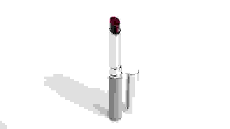 A silver tube of Clinique lipstick uncapped to reveal a berry-toned shade.