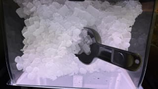 Close up photo of ice with scooper.