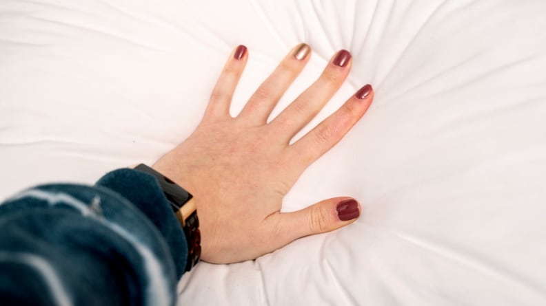 a hand presses into the casper original pillow