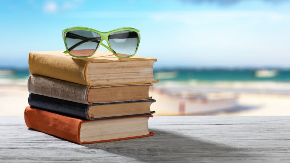 Books and sunglasses in a pile at the beach