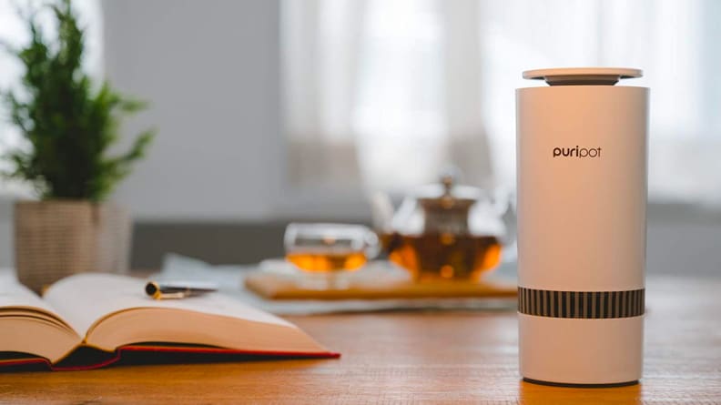 The Puripot M-Series air purifier sitting on a home desk.