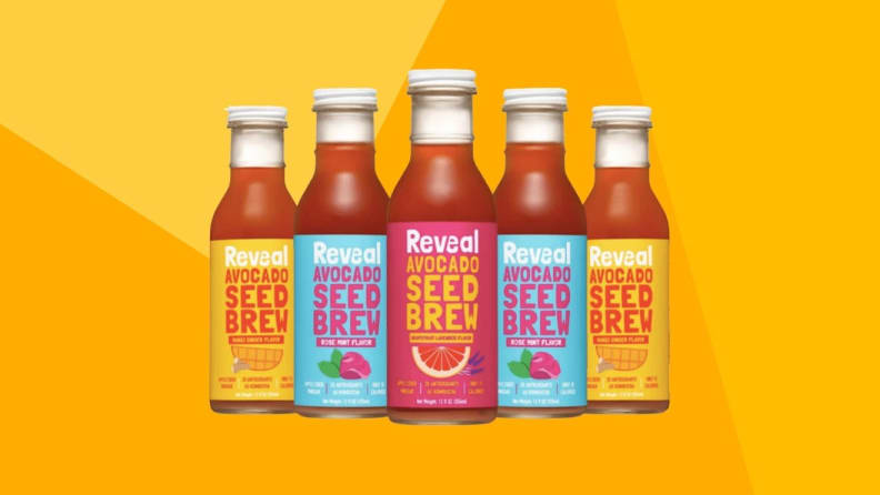 Five bottles of juice bottles against a yellow background.