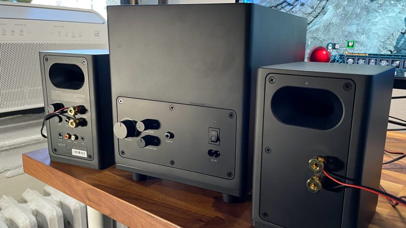 The back of three NZXT Relay Speakers and Relay Subwoofer's and the inputs: RCA, TRS; Outputs: subwoofer, speaker terminals.