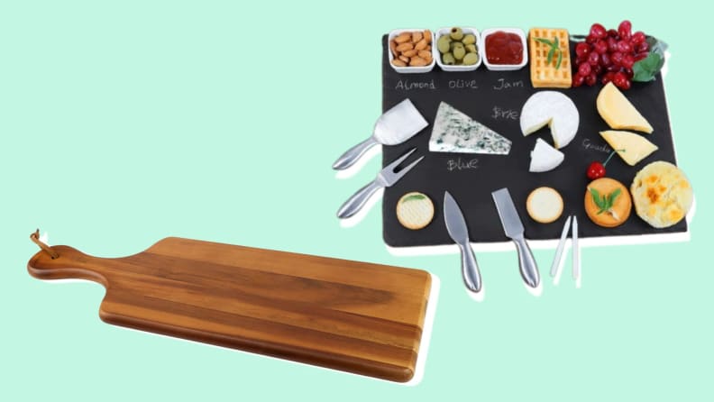 Empty wooden cheese board and slate cheese board filled with cheese on a blue background