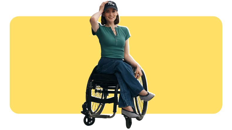 A woman in a wheelchair wearing a green, fashionable top from Anthropologie