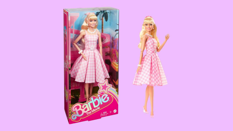A Barbie in a pink gingham dress waves and stands next to another version of herself in her package.