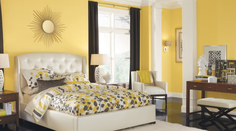 A yellow bedroom brings its own sunshine