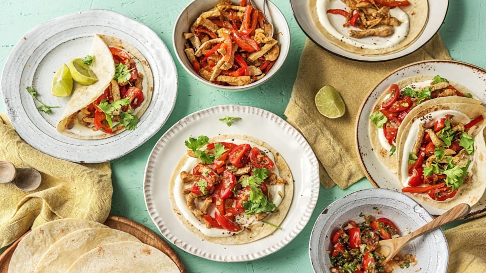 A table full of colorful tacos.