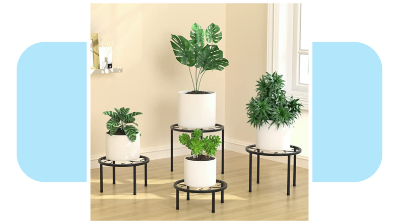 Four potted plants on top of the Uneeedem 4-Pack Metal Plant Stand indoors.