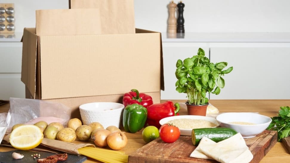 Meal kit box with ingredients laid out in front