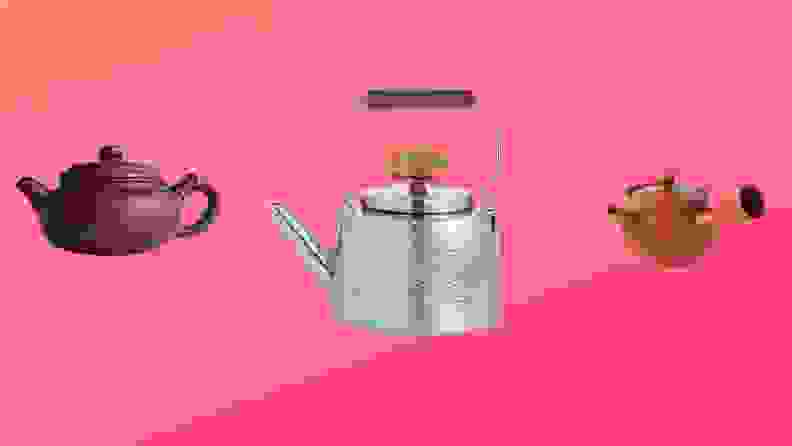 Three teapots in front of a background.