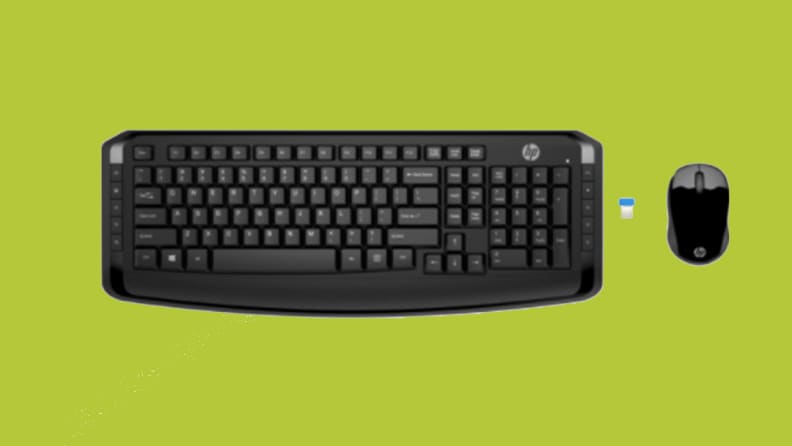 An image of a black keyboard seen from above, alongside a small computer mouse and a USB chip.