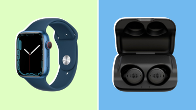 Navy blue smart apple watch next to black ear buds.