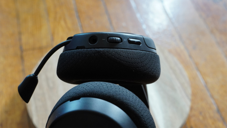 A pair of SteelSeries black headphones with the volume controls visible.