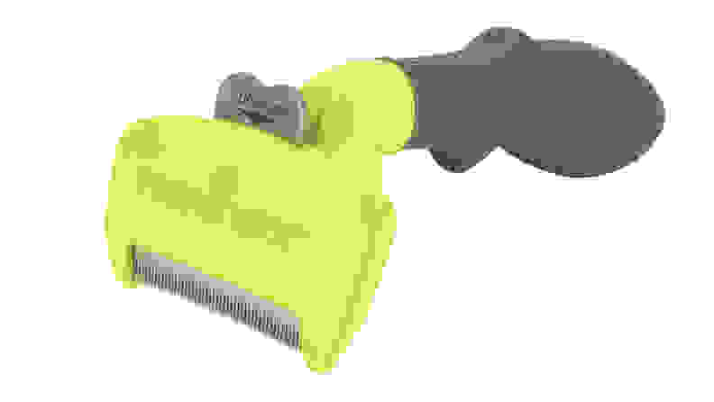 A neon yellow cat hair removal tool on a white background