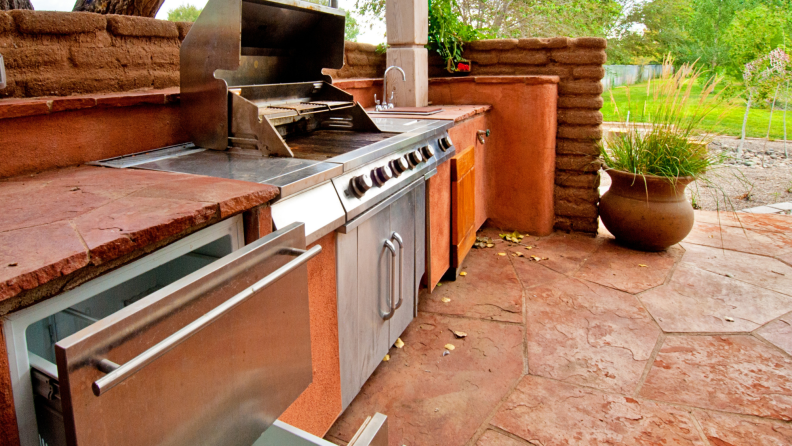 An outdoor kitchen in warm stone