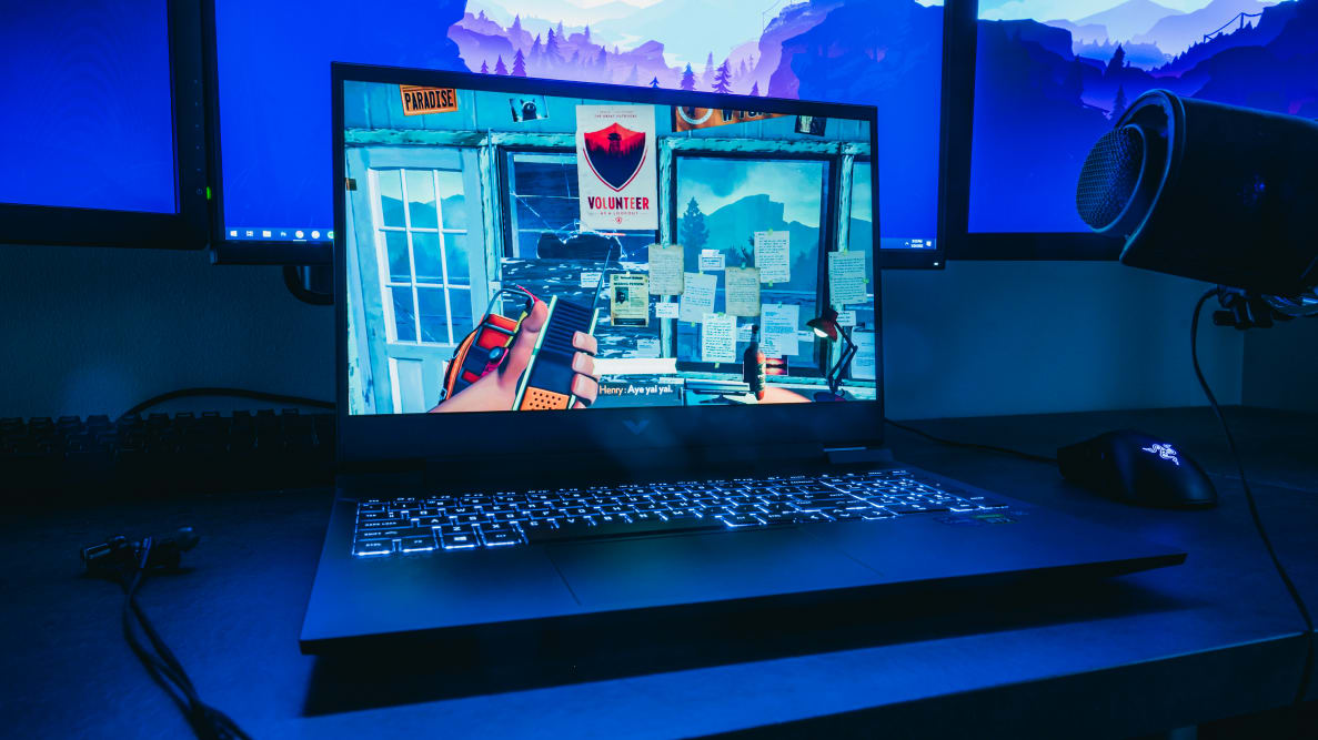 An open laptop open on a dark desk