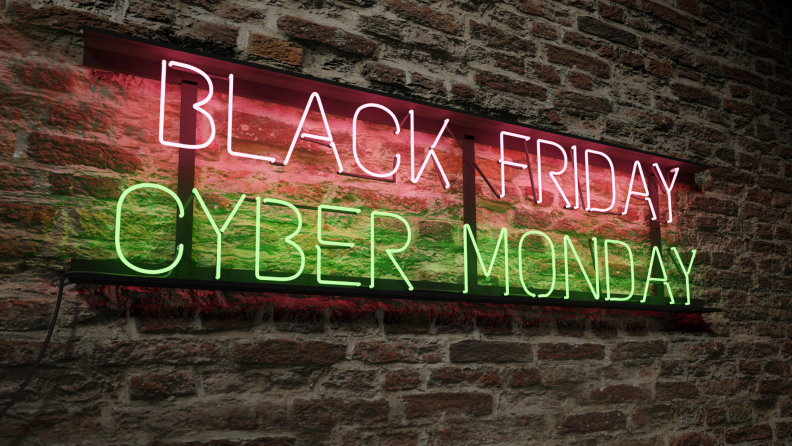 A brick wall with a neon sign that says Black Friday Cyber Monday