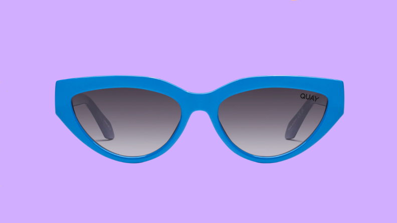 An image of a pair of bright blue cat-eye sunglasses.