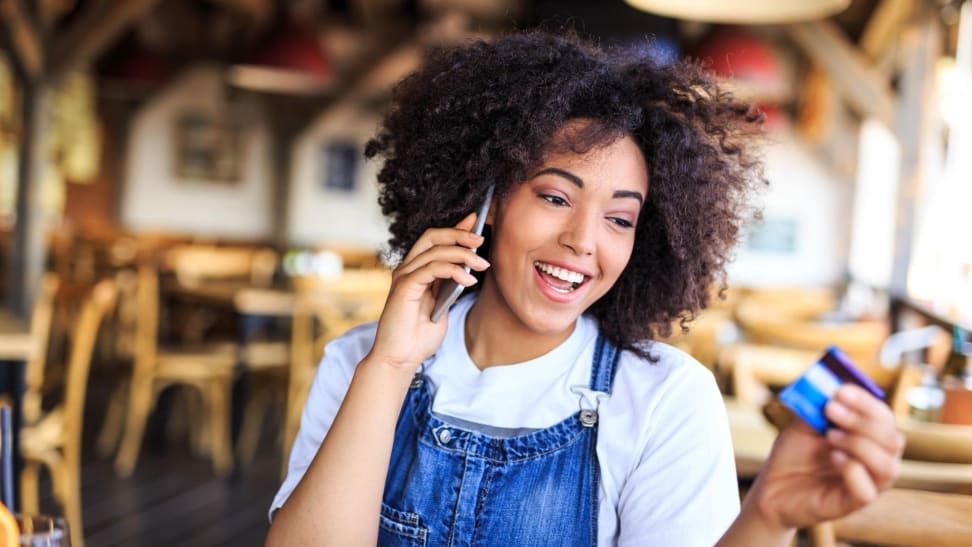 Woman calling bank to transfer credit card balance