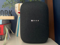 Google's Nest Audio smart speaker sits on a shelf.