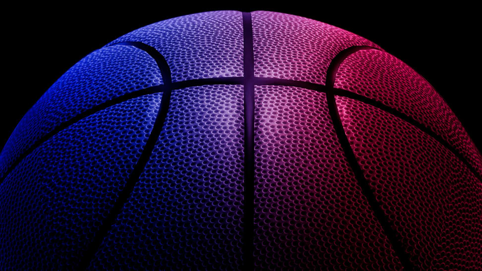 An image a red, pink, purple, and blue basketball seen up close.