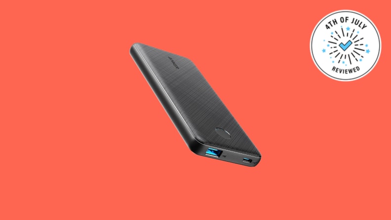 A portable charger against an orange background.
