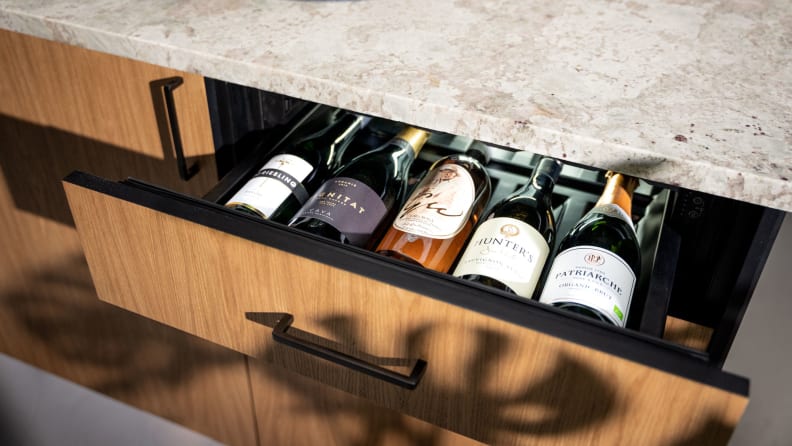 A kitchen drawer opens to reveal wine storage for five bottles.
