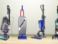 Four vacuums on a wooden floor in front of a wall