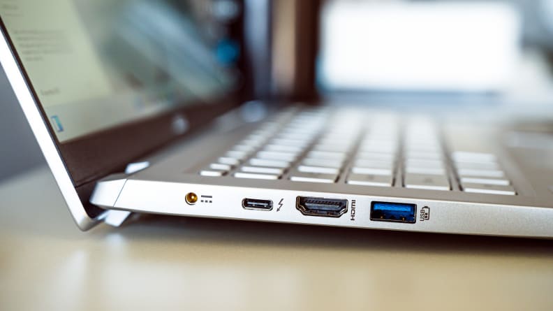 A close up of connectivity ports on the side of a silver laptop.