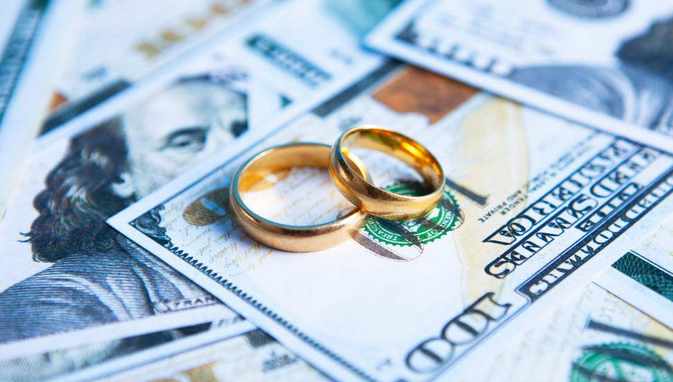 Wedding rings on top of cash.