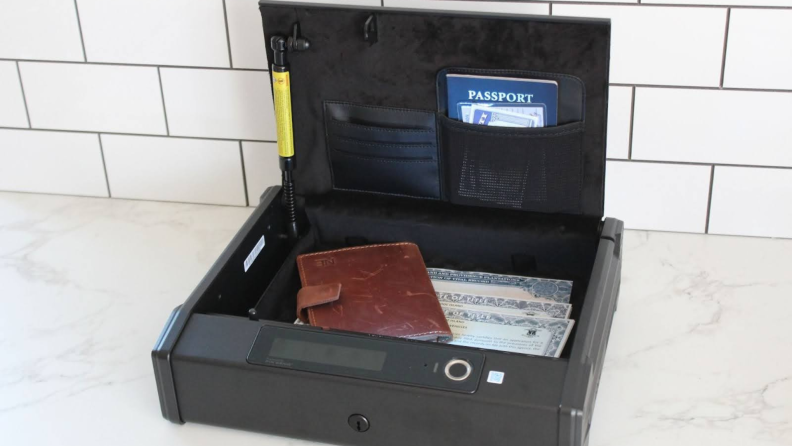 The Lockly Smart Safe open with several important documents inside.