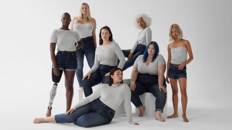 women standing in a group together in front of white backdrop