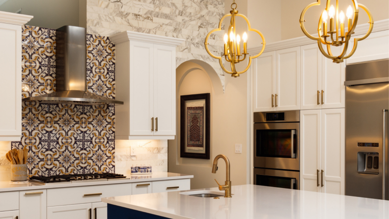 Designers and home owners alike are mixing up metals in the kitchen, like mixing stainless steel appliances and range hood with brass lighting elements and cabinet hardware.