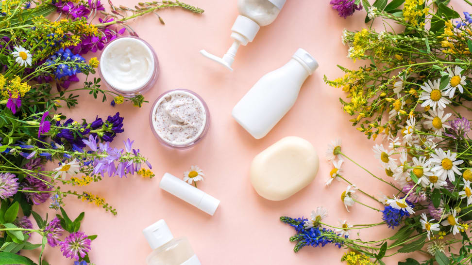 Flowers against a pink background with all-natural eco-friendly products.