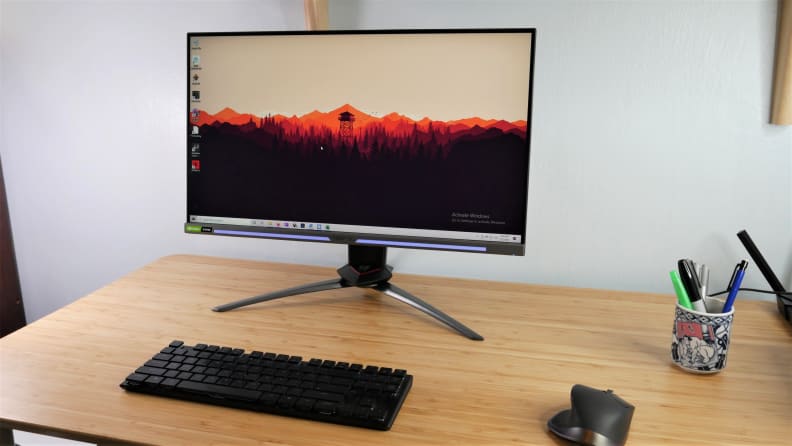Monitor on desk with keyboard, pen stand and mouse