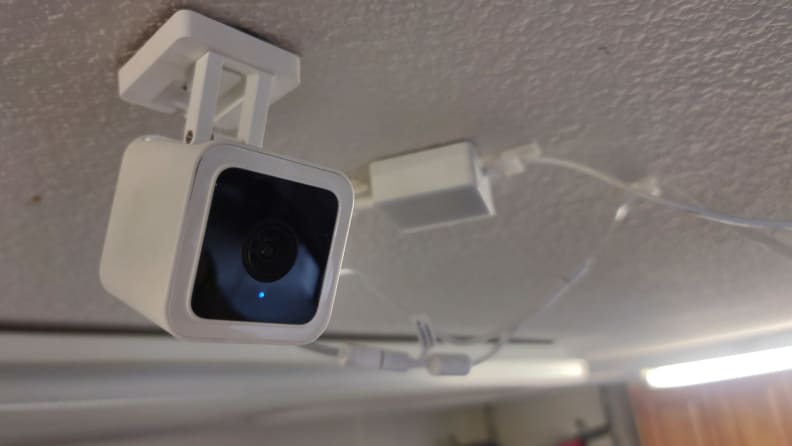 A security camera hangs from a garage cieling