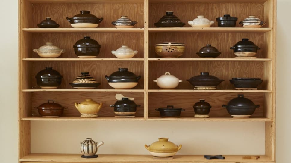 Shelves filled with Japanese donabe clay pots.