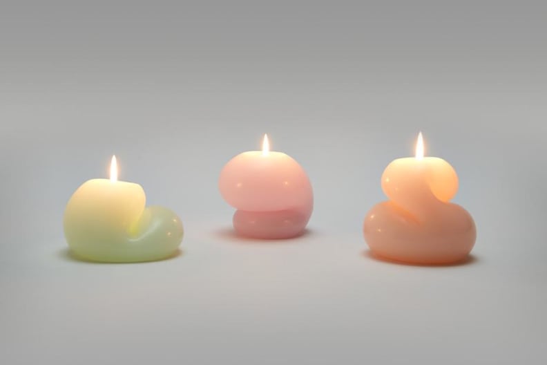 Three blob shaped candles lit up