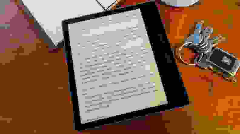 The Kindle Oasis, rested on a table, showing text from a book.
