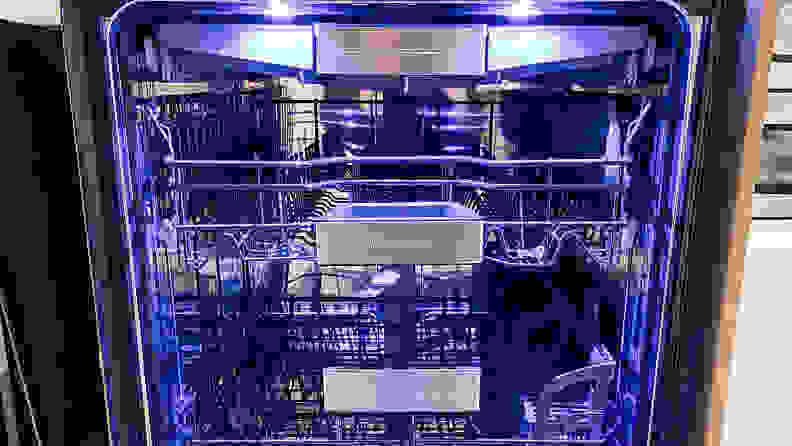 A shot of the interior of the Thermador DWHD770WFM dishwasher, awash in sapphire blue light.