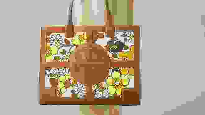 Brown leather handbag with yellow flowers