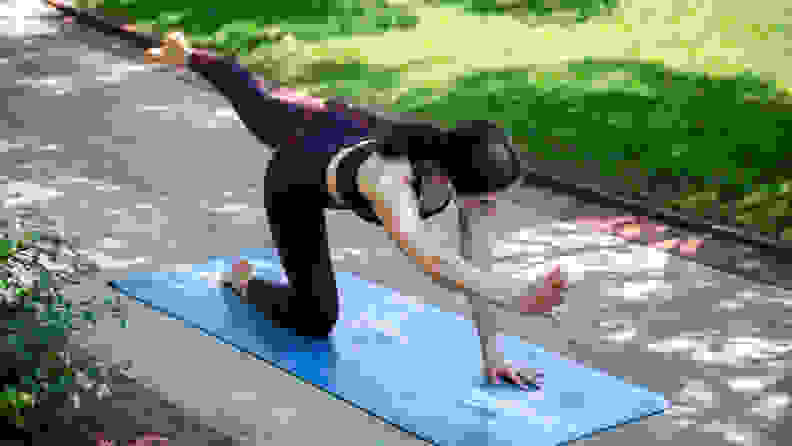 Woman working out on lululemon yoga mat.