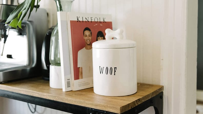An image of a white jar of dog treats emblazoned with the word 