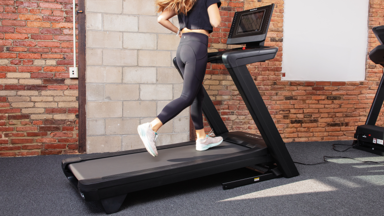 A woman running on the NordicTrack Commercial 1750 treadmill.