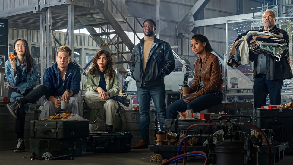 Cast of "Lift" standing in a warehouse.