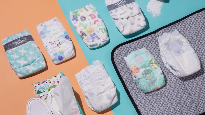 An array of baby diapers from Pampers, Millie Moon, Coterie and Honest lined up in a row.