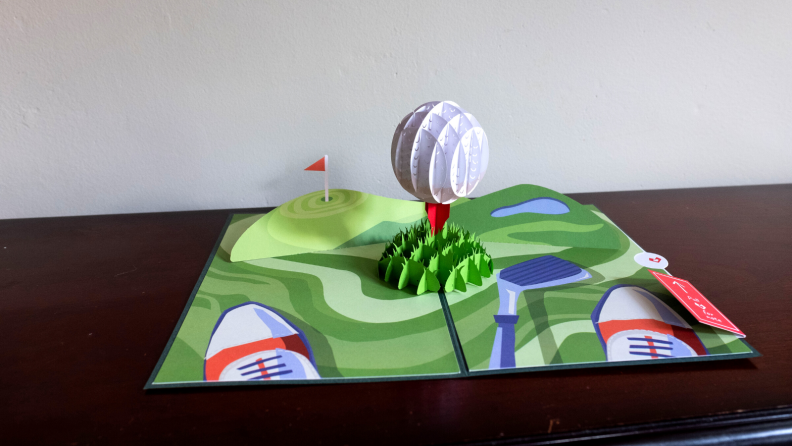 Popup card with golf ball in the middle.