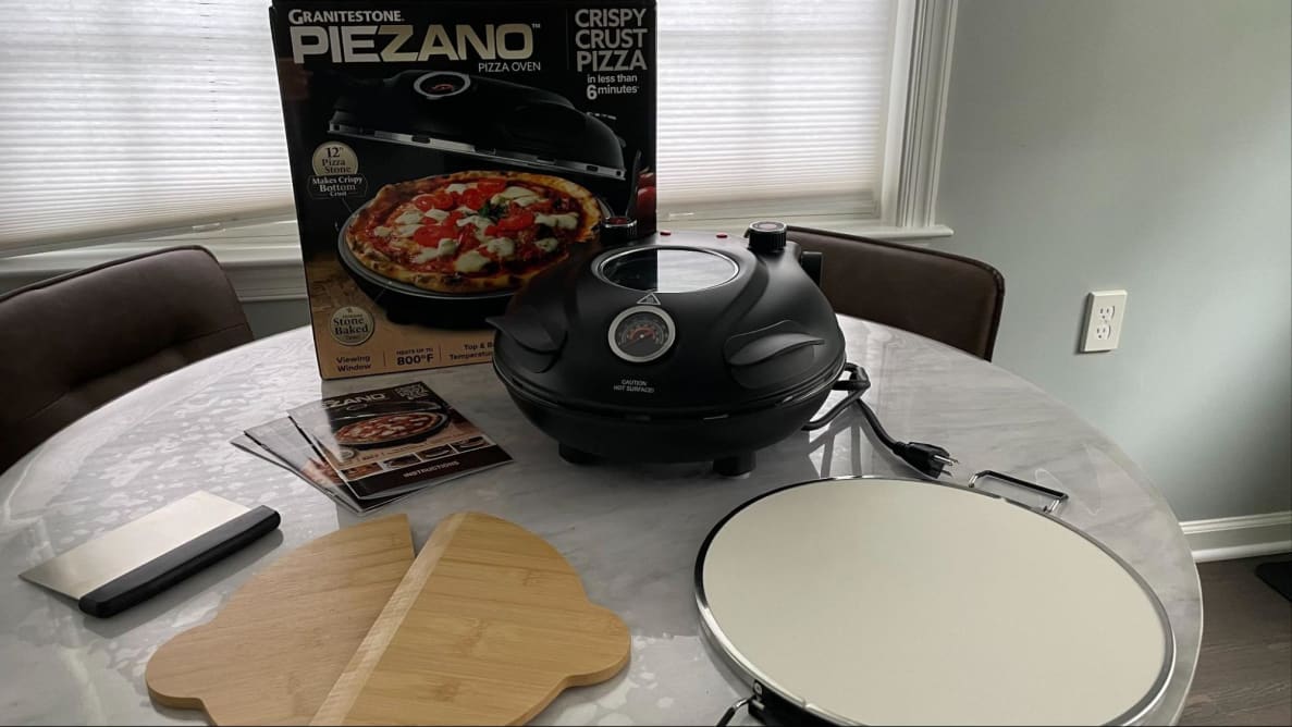 The Piezano Pizza Oven atop a table.