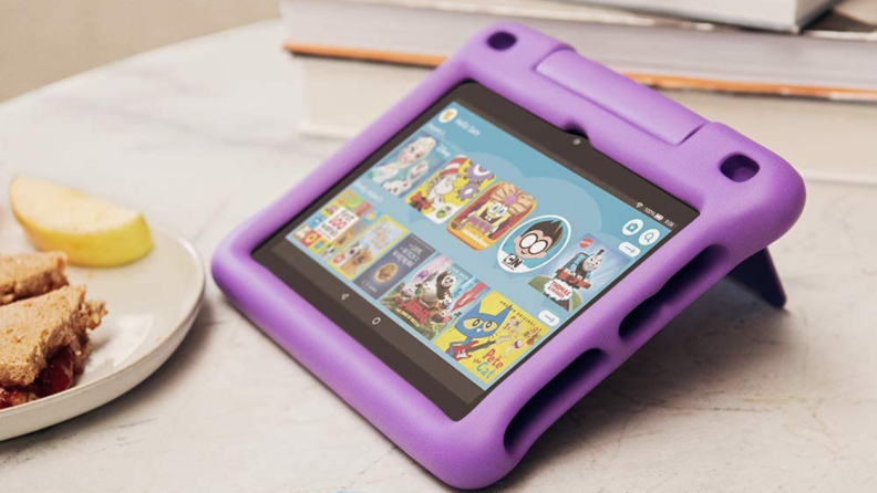 A pink Amazon tablet for kids on a breakfast table.